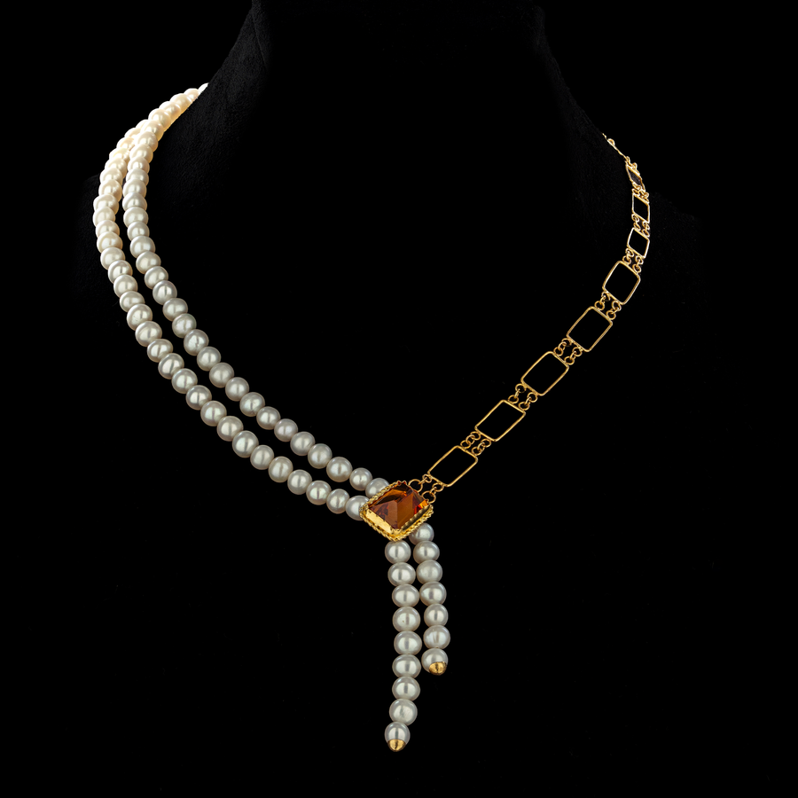 Zaman's Legacy necklace: Timeless elegance. Lustrous pearls, radiant topaz, and modern gold create a cherished heirloom.