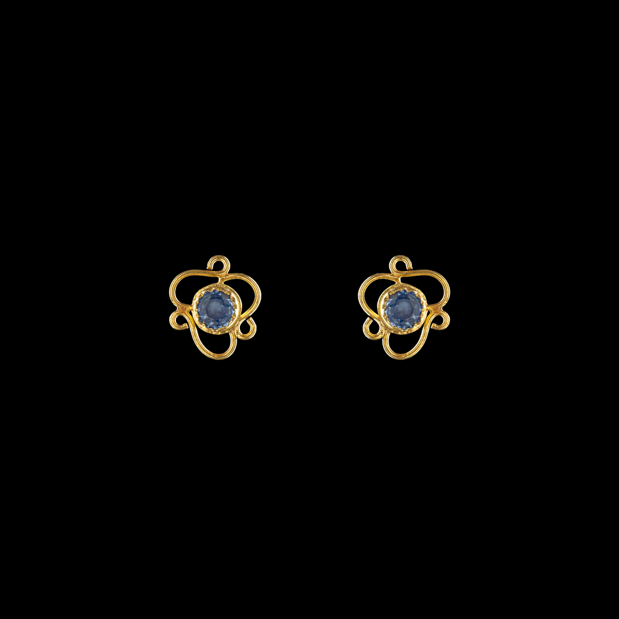 Skylit light blue sapphire stud earrings set in 21 karat gold, offering elegance and timeless beauty.