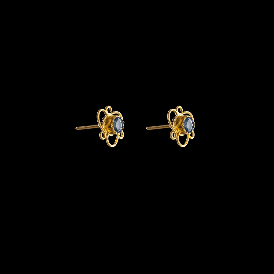 Skylit light blue sapphire stud earrings set in 21 karat gold, offering elegance and timeless beauty.